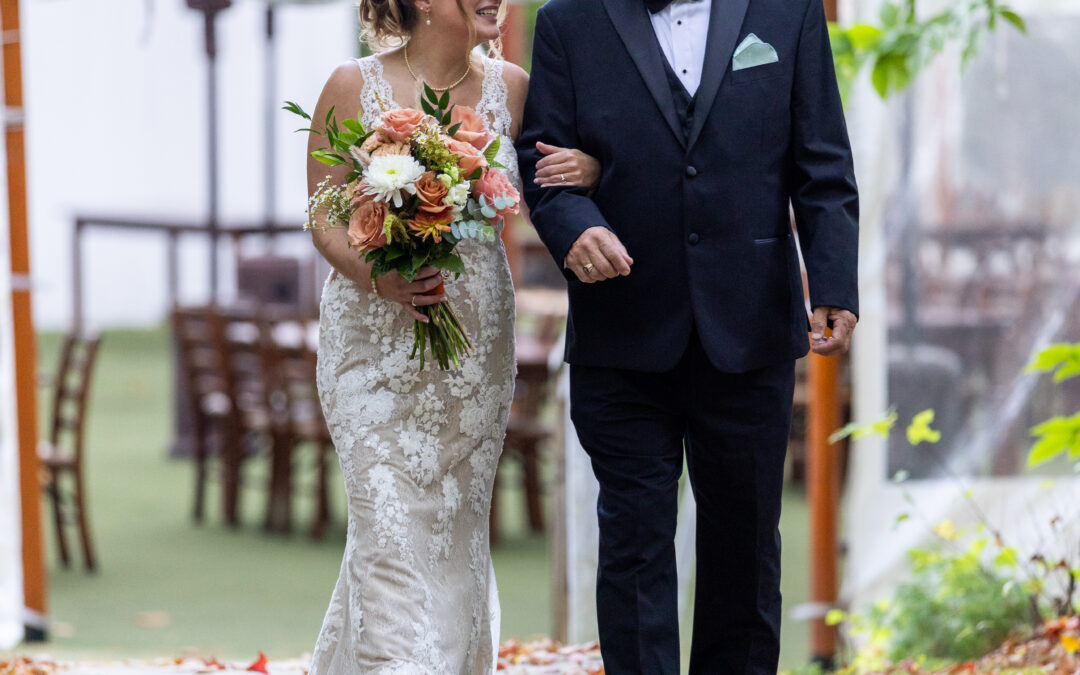 Life In Focus Maine Photographers, bride is walked down the aisle by father, fall leaves are scattered on the ground
