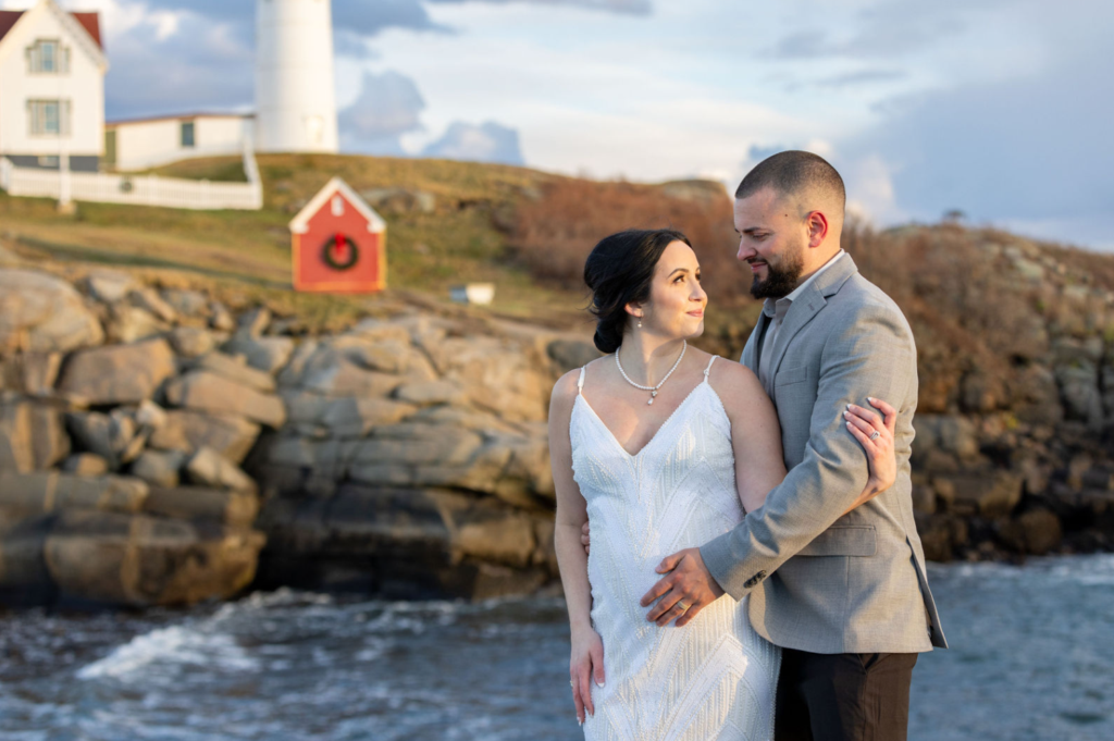 Life In Focus York Maine Wedding PhoLife In Focus York Maine Wedding Photographer, newlyweds pose in front of Nubble Lighthouse